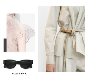 Close-up of black rectangular sunglasses with arrow rivets and beige rope belt accessory