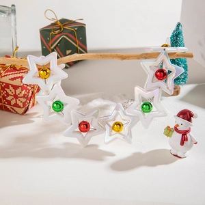 Close-up of white star chain bracelet with colorful bells in festive Christmas scene