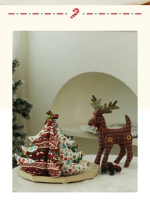 Detailed close-up of cloth Christmas tree and reindeer ornaments on a tray