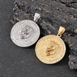 Detail of hip hop lion head pendants with crystals in gold and silver finishes