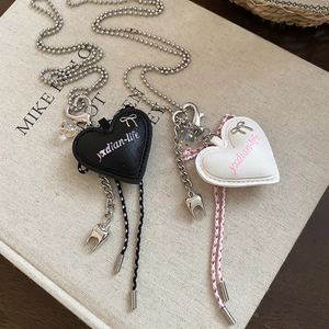 Sweet heart bow and tooth pendant necklace in black and white leather with metal chain