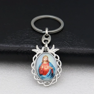 Detail of Sacred Heart of Jesus keychain with an ornate oval silver metal frame