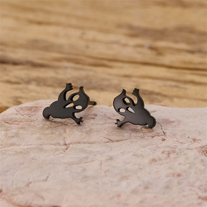 Macro detail of cute black cartoon ghost stud earrings made of stainless steel for Halloween