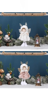 Detail view of plush Christmas angel ornaments with lace skirts and glitter wings