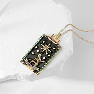 Macro view of gold tarot card pendant necklace with The Star motif and colorful gemstones