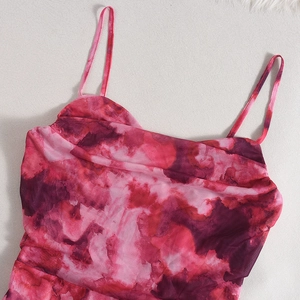 Detail of rose pink tie-dye mesh bodysuit showing thin straps and neckline texture