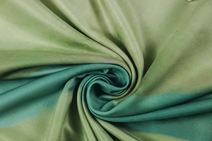 Macro shot of green gradient twill fabric showing detailed spiral pleat and texture