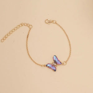 Detail of gold butterfly necklace with purple iridescent pendant and lobster clasp