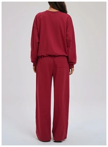Detail view of burgundy hoodie set featuring a drop shoulder design and rear patch pocket