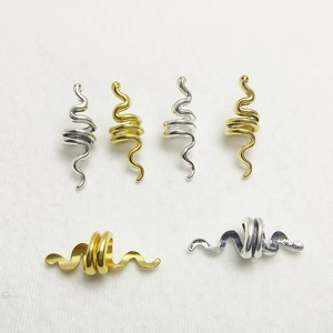 Detailed view of snake-shaped hair rings in gold and silver finishes for DIY braiding