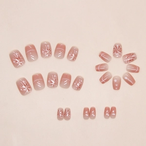 Detail of blush gradient press-on nails with silver glitter stars and fireworks pattern