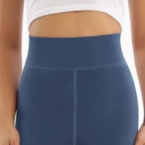 Detail of high waisted yoga leggings in misty blue featuring a wide ribbed waistband