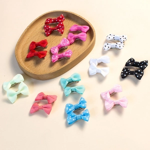 Close-up of handmade colorful grosgrain ribbon hair clips with solid colors and polka dots