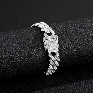 Macro shot of silver Cuban link bracelet with clear zircon stones on black leather