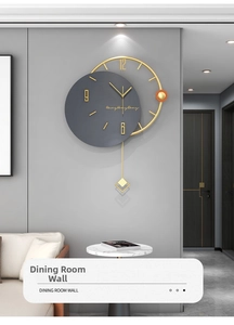 Detail of modern gray wall clock featuring gold 3D numbers and a minimalist gold pendulum