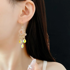 Detail of bohemian floral tassel earrings featuring colorful drop-shaped zircon crystals
