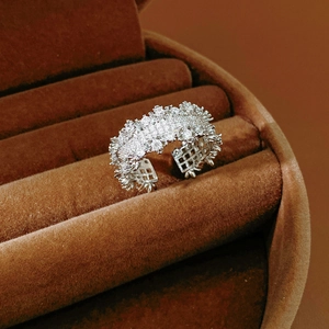 Macro shot of silver open band ring with zircon pave setting in a velvet box