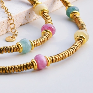 Macro view of gold-plated stainless steel chain with colorful tourmaline beads and clasp