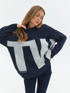 Detailed view of navy blue oversized knit sweater featuring white TN since 2017 jacquard