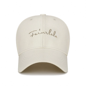 Front view of beige cotton baseball cap with elegant gold cursive letter embroidery