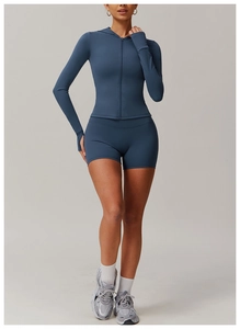 Detail of dark blue hooded zipper jacket with thumbholes and high-waist fitness shorts