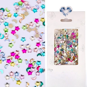 Macro view of assorted star and moon nail art crystals with professional box packaging
