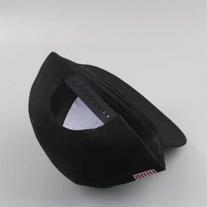 Detail view of the adjustable black snapback closure and side tag on the hip hop cap
