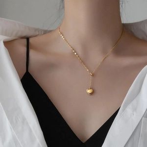 Polished 18K gold titanium steel heart pendant necklace on female model neck