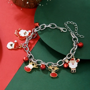 Detailed shot of Christmas charm bracelet with Santa, reindeer, and red jingle bells