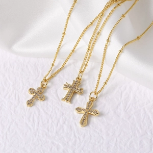 Golden cross pendant necklace set with sparkling white zircons and bead chain