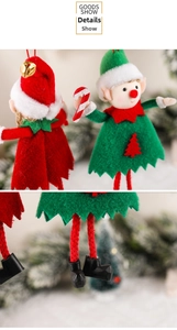 Close-up of Christmas elf dolls with red and green outfits and festive bell details
