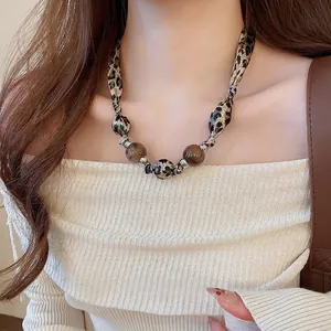 Collier à motif léopard avec perles en résine ambrée et détails argentés chics