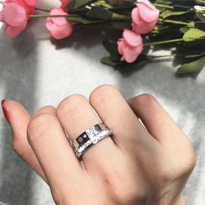 Detail of silver stackable ring set with Roman numerals and pavé cubic zirconia