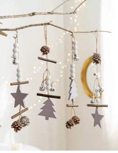 Macro shot of 4 Nordic style wooden Christmas tree ornaments with pinecones and metal bells