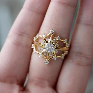 Bohemian gold starburst ring with round center zircon and micro-pave detailing on finger