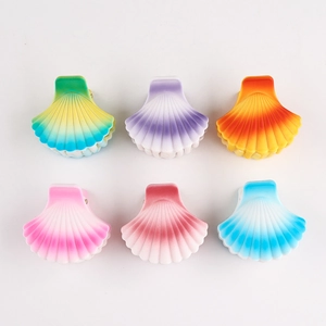 Close-up of six colorful gradient shell hair clips in various bright pastel shades