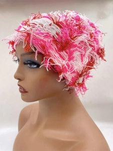 Detail of pink and white knitted tassel fringe texture on the funny camouflage beanie