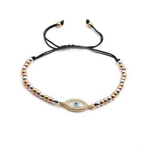 Detail of adjustable evil eye charm bracelet with gold beads and black woven cord