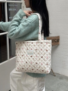 Close-up of quilted cotton tote bag featuring cute cartoon bear prints and soft texture