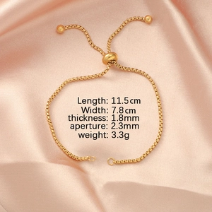 Macro detail of adjustable golden stainless steel bolo bracelet on pink satin fabric