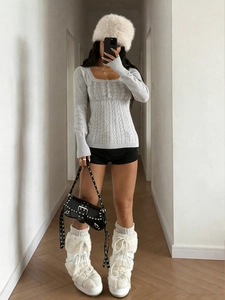 Detail showing the gray slim-fit square neck knit sweater and cable-knit texture detail