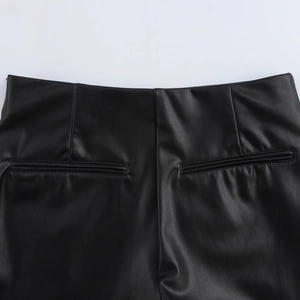 Close-up of rear waist detail with dual welt pockets on black PU leather shorts