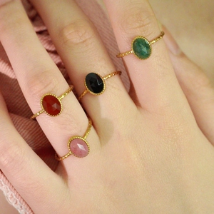 Set of four gold-toned twisted band rings with colorful oval faceted gemstones for women