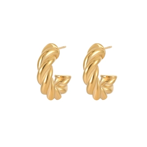 Close-up of golden twisted rope hoops with a croissant texture and polished finish