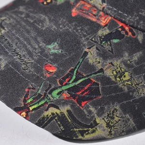 Detail of colorful graffiti print and reinforced stitching on black cotton baseball cap