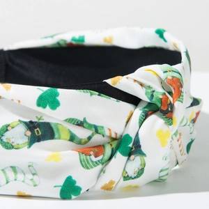 Detail of St. Patrick's Day knotted headband with green clover and leprechaun prints