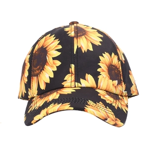 Detailed close-up of vibrant sunflower print on black baseball cap with durable stitching