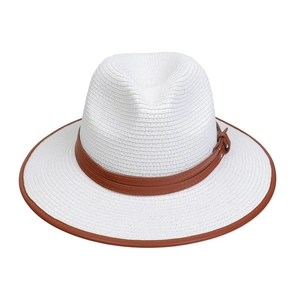 Close-up of white woven straw hat featuring a brown leather belt trim and edged brim