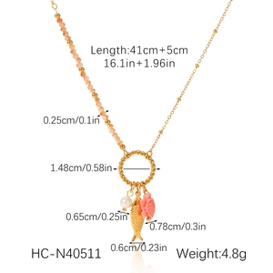 Detail view of turtle and fish ocean pendants with pearl on a beaded necklace length 41+5cm