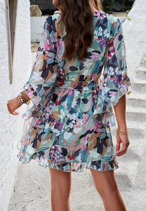 Detailed back view of a floral chiffon dress with ruffled cuffs and matching waist tie